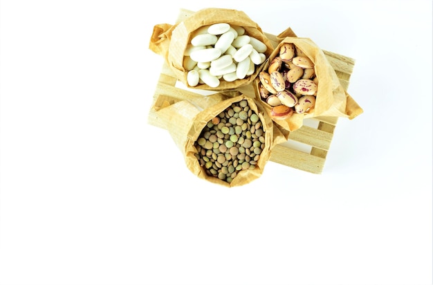 Top view shot of beans and lentil on a white background