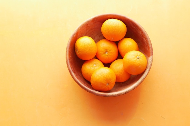 Top view of slice of orange fruits in a bowl