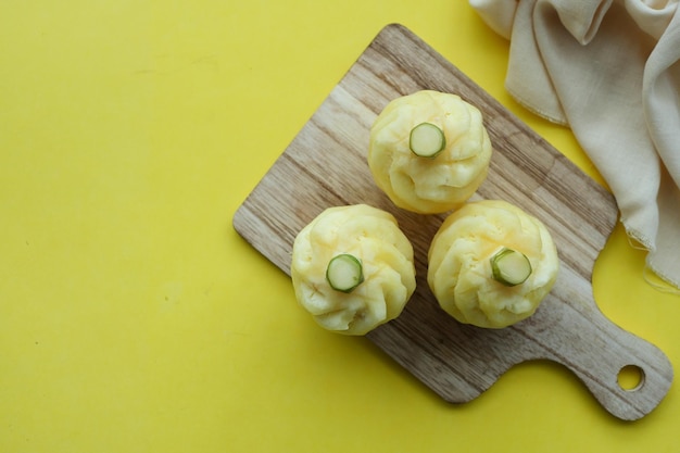 Top view of slice of pineapple on yellow background with copy space