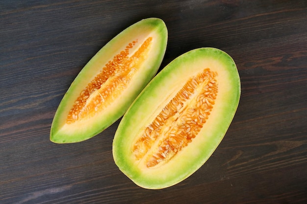 Top View of Slices of Juicy Fresh Ripe Thai Melon on Black Wooden Table