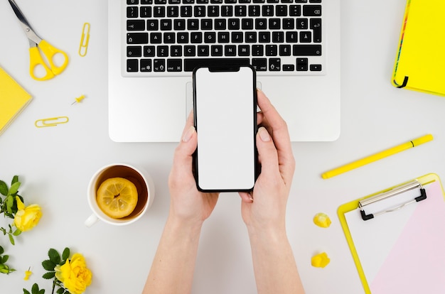Top view smartphone template over workspace