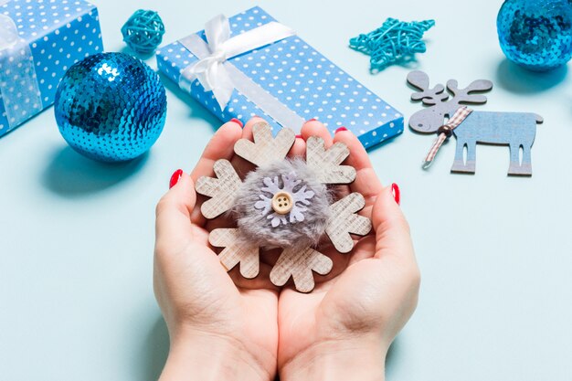 Top view of snowflake in female hands. Christmas decorations. New Year holiday concept