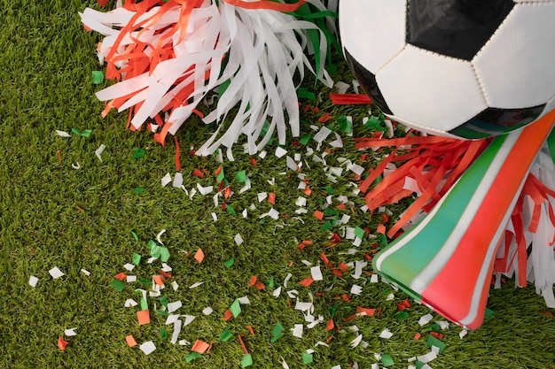 Top view of a soccer ball with green red and white party favors