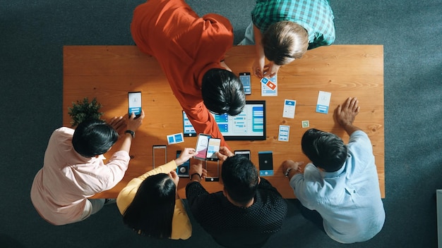 Top view of software developer team looking ux design from tablet convocation