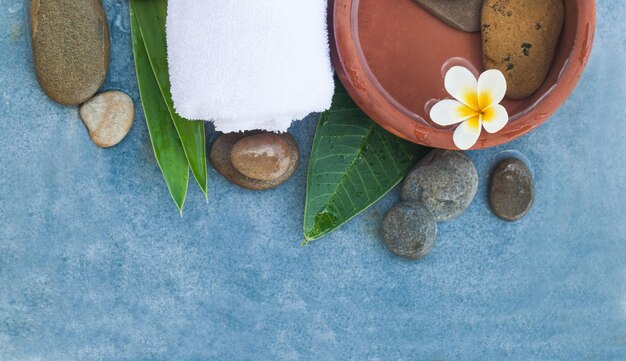 Top view of spa objectswith tropical flower and stones for healthy massage