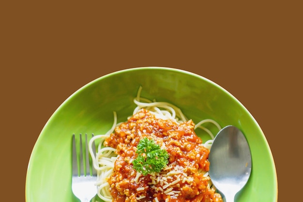 Top view of spaghetti tomato sauce and minced pork look tasty with spoon and fork on ceramic plate a