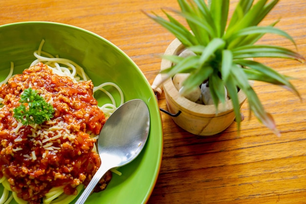 Top view of spaghetti with minced pork and tomato sauce look tasty on ceramic plate