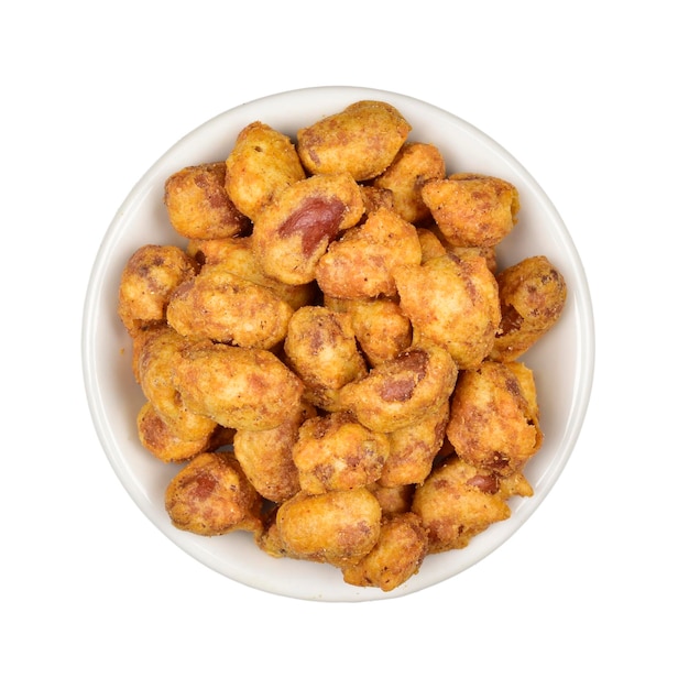 Top view of spicy coated peanuts in bowl isolated on white background with clipping path