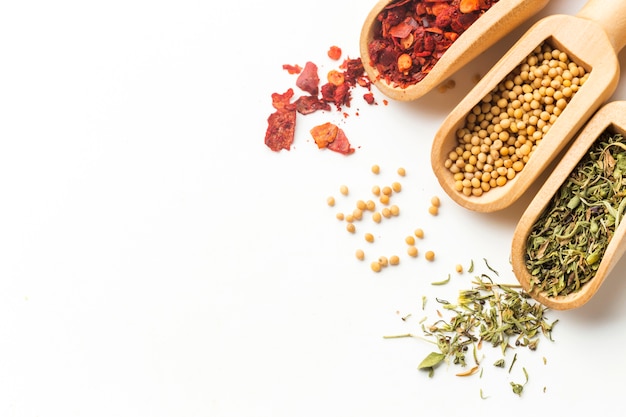 Top view spoons with spices on table