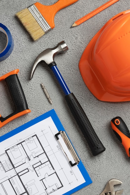 Top view of steel hammer with other construction elements and tools