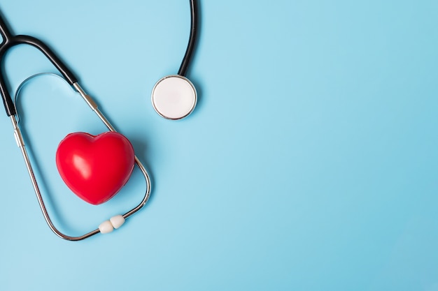 Top view Stethoscope with Red heart shape on blue background with copy space for text. Healthcare, life Insurance, Health day, World Heart Day and Happy Doctor day concept