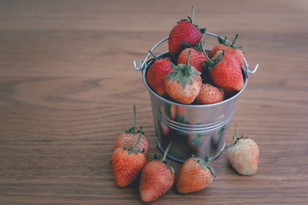 Top view Strawberries in bow on wooden background. Beautiful red strawberry