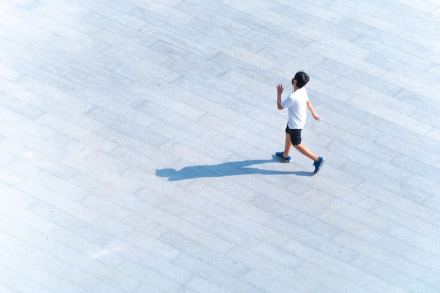 Top view of student with fashion cloth and sport wear walking at pedestrian walkway