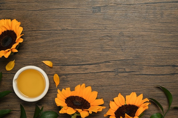 Top view of sunflower seed oil and sunflower on rustic table Agriculture organic product healthy oils food