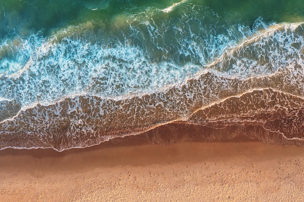 Top view of the surf lie Waves and sandy beach Artistic redgreen gradient color