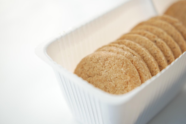 Top view of sweet cookies in a plastic packet on wooden table