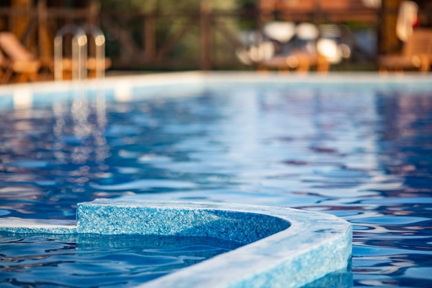 Top view of swimming pool with clear water on vacation on sunset background