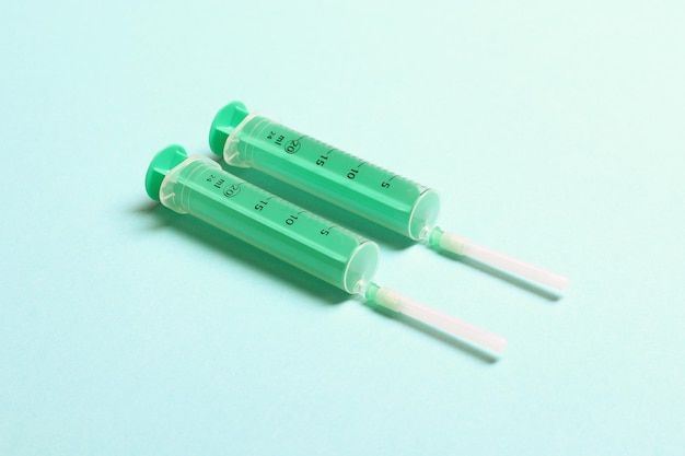 Top view of syringes in a row for medical injection on colorful background with copy space Health and vaccination concept