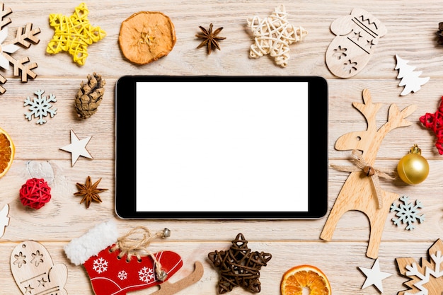 Top view of tablet on holiday wooden background