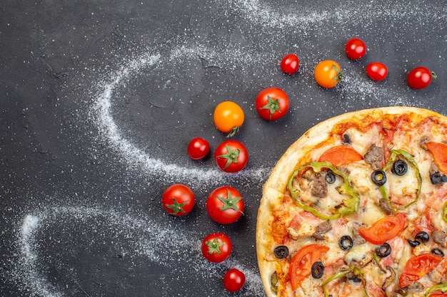 Top view tasty cheese pizza with red tomatoes on dark surface