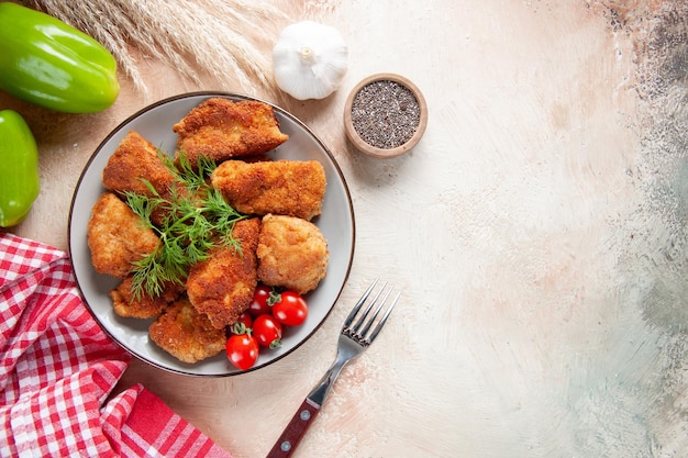 Top view tasty chicken wings with greens and tomatoes on light background burger food meal lunch sandwich fries