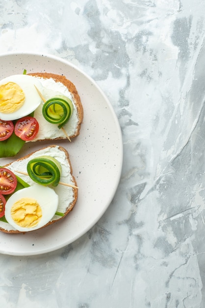 top view tasty egg sandwiches with tomatoes inside plate white surface background lunch sandwich food bread burgers health diet meal