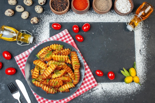 Top view tasty fried potato with seasonings and red tomatoes on dark background dish photo cooking food meal meat chicken