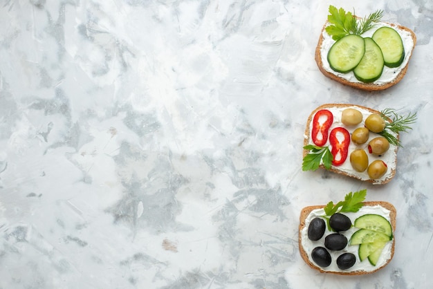 Top view tasty sandwiches with cucumbers and olives white background lunch food sandwich horizontal meal burger bread toast free space