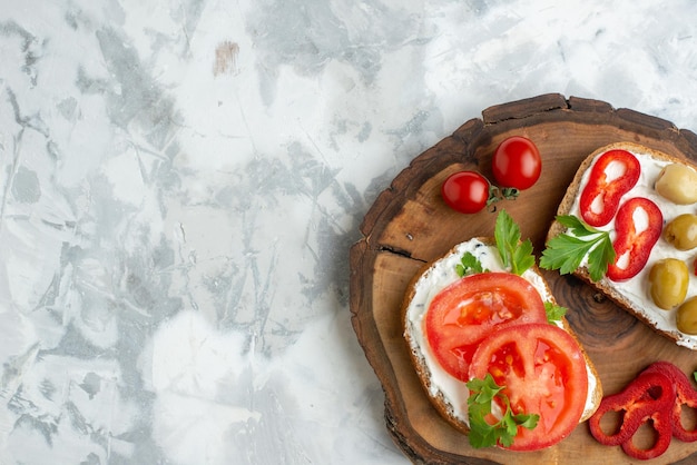 Top view tasty toasts with tomatoes and olives on wooden board white background burger bread meal horizontal food dinner sandwich