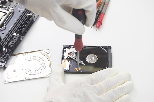 Top view technician repairing hard disk