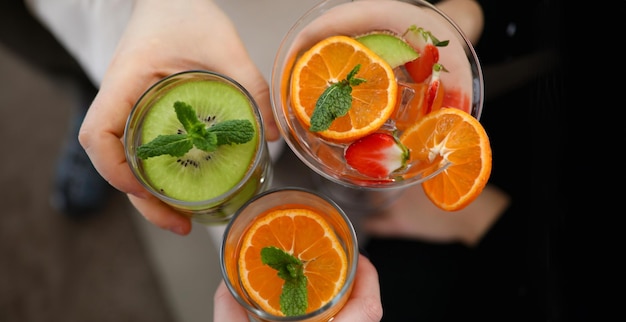 Top view of three different delicious cocktails with mint and juicy fruits