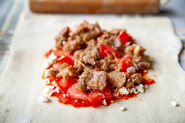 Top view tomato filling with meat and cheese and red chili pepper sauce with spices for burritos