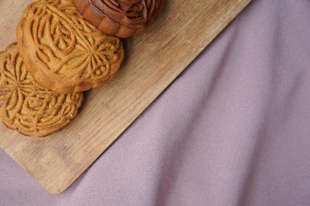 Top view of traditional Chinese mid-autumn festival mooncake on beige cloth.