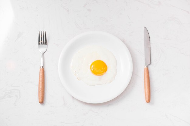 Top view of traditional healthy easy quick breakfast meal made of fried eggs served on a plate.