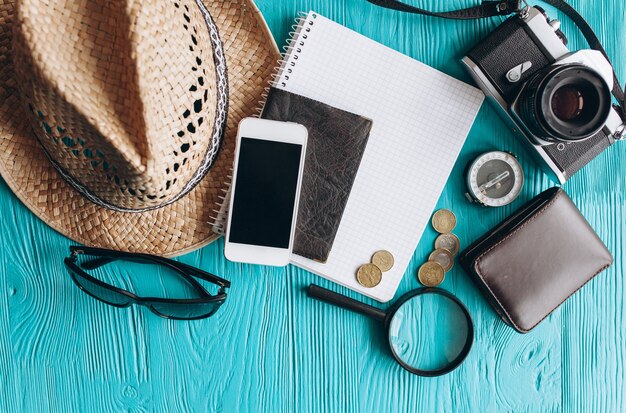 Photo top view of travel accessories set on wooden blue  background with copy space