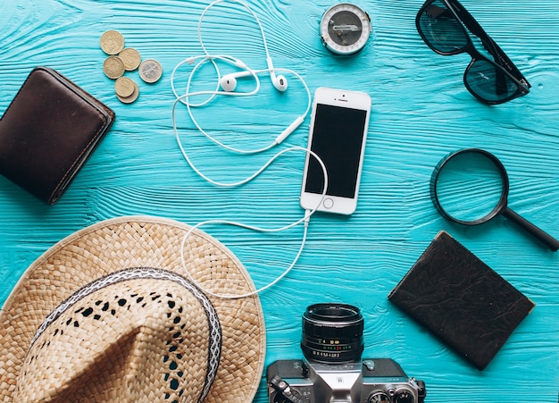 Photo top view of travel accessories set on wooden blue  background with copy space