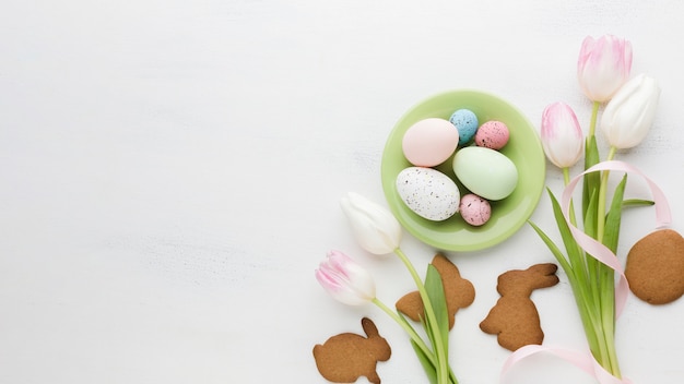 Top view of tulips with multicolored easter eggs