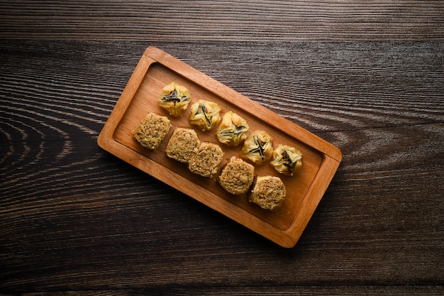 Top of view Turkish Baklava sweet pastry on wooden tray Isolated wooden background