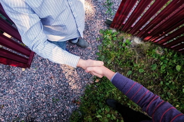 Top view of two men shaking hands while standing outdoor