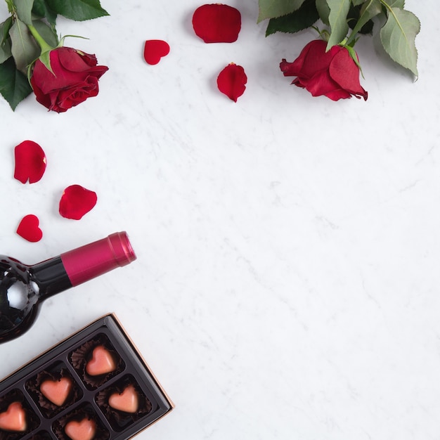 Top view of Valentine's day chocolate with rose and wine