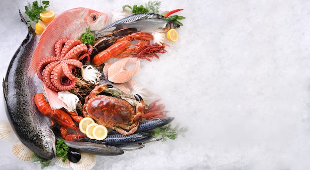 Top view of variety of fresh fish and seafood on ice