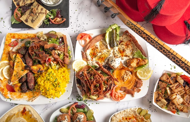 Top view of a variety of Middle Eastern and Arabic food dishes on a white background