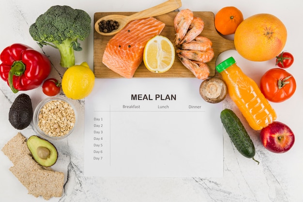 Top view of vegetables and salmon with plan