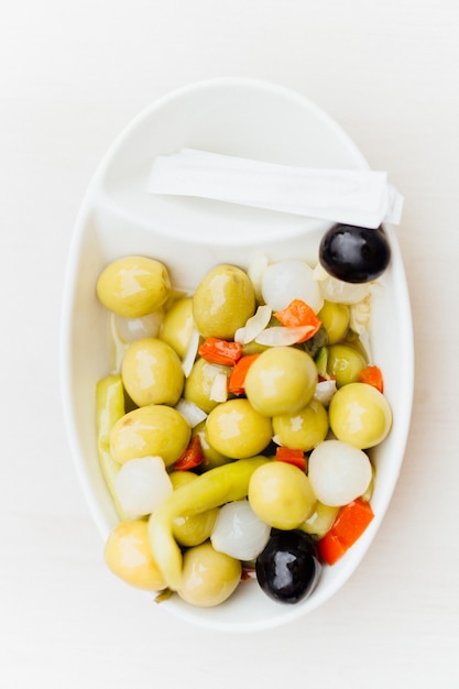 Top view of vegetarian or vegan snack consisting of olives, chilli, chives, and red pepper. healthy snac concept. Mediterranean diet. Spain