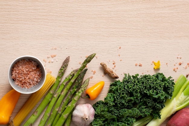 Top view veggies, raw spaghetti and himalayan salt with copy-space