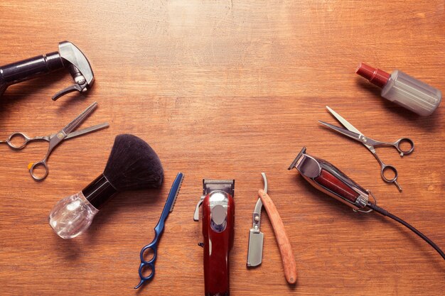 Top view of vintage barbershop tools on wooden background, flat lay overhead view