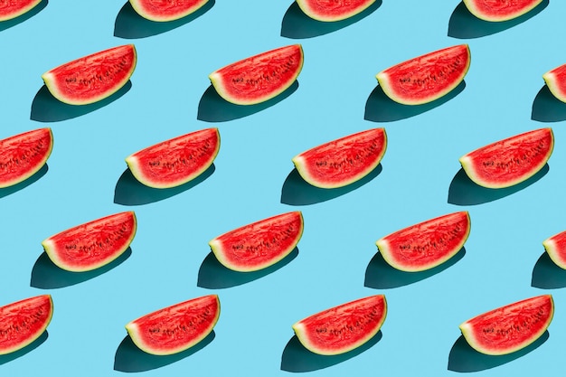 Top view of watermelon slices on blue background. Watermelon colorful pattern