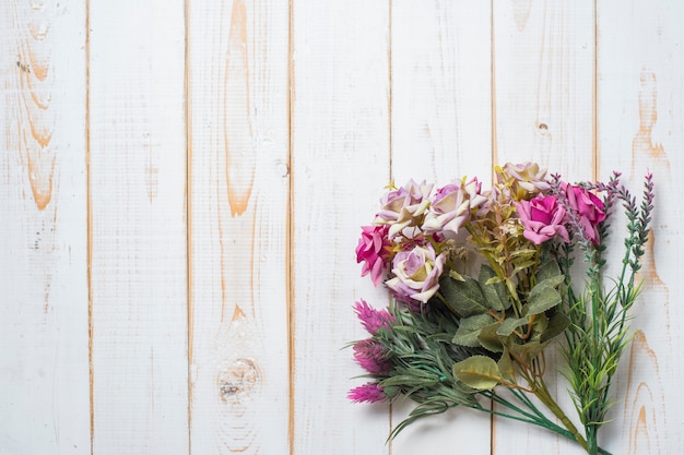 Top view of wedding flowers on white wood background 