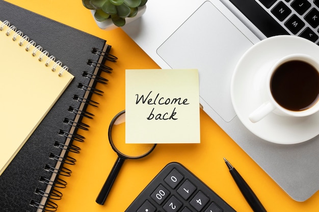 Top view welcome back message with coffee cup