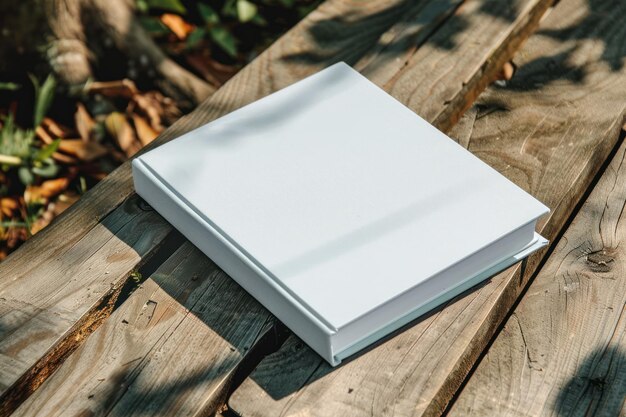 Photo top view white book mockup with textured hardcover on wooden table outdoors